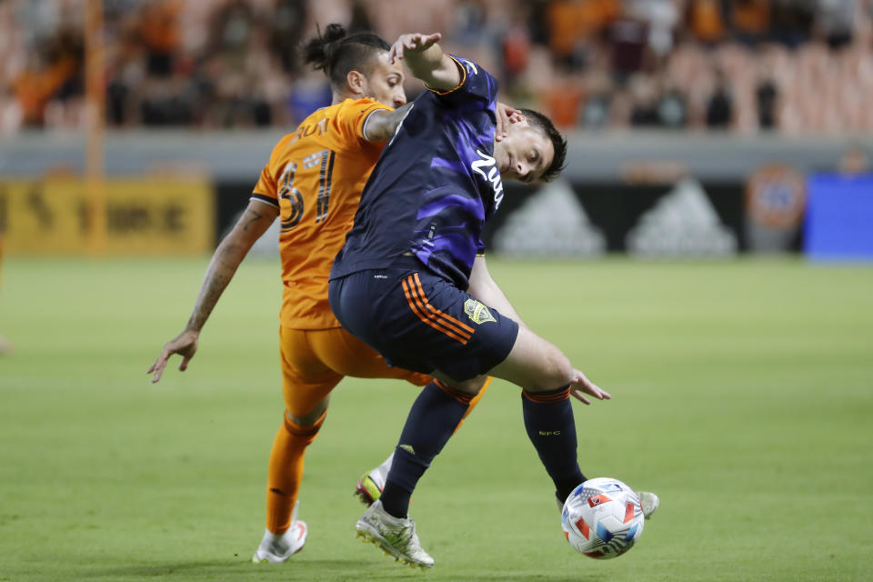 Houston Dynamo forward Maximiliano Urruti (37) pulls Seattle Sounders defender Shane O'Neill, right, during the first half of an MLS soccer match Saturday, Oct. 16, 2021, in Houston. (AP Photo/Michael Wyke)