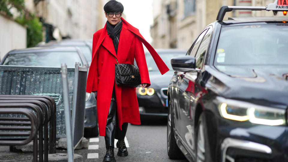 PARIS, FRANCE - MARCH 03: Kenneth Goh, Harper's Bazaar Singapore Editor-in-Chief, wears a scarf, a red double-breasted coat, a black Chanel bag, black leather pants, black platform shoes with eyelets, outside Valentino , during the Womenswear Fall/Winter 2024/2025 as part of  Paris Fashion Week on March 03, 2024 in Paris, France. (Photo by Edward Berthelot/Getty Images)