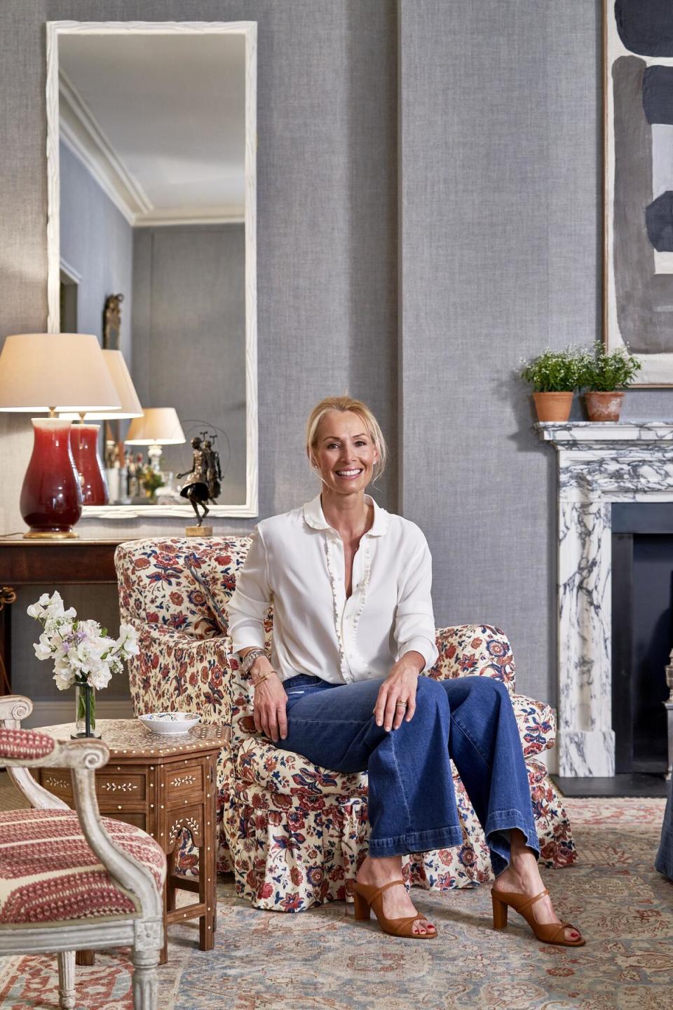 Vanessa Macdonald wrapped the drawing room in blue linen wallpaper, then added antiques and a mix of prints to achieve a quintessentially English look