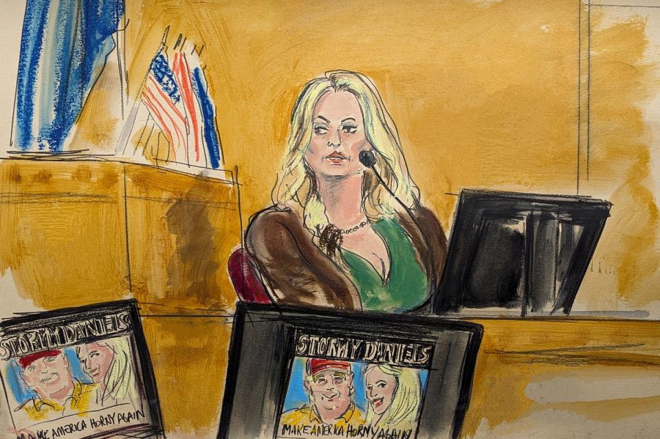 Stormy Daniels testifies on the witness stand as a promotional image for one of her shows featuring an image of Trump is displayed on monitors in Manhattan criminal court, Thursday, May 9, 2024 (AP)