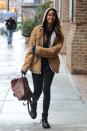 <p>She escapes in winter chill in a tan hooded shearling jacket, a turtle neck and trademark skinnies. <i>(Photo via Getty Images)</i> </p>