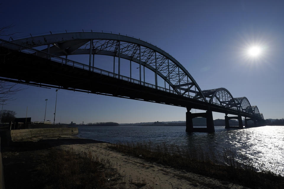 The Centennial Bridge is seen over the Mississippi River, Monday, Dec. 20, 2021, in Davenport, Iowa. The 81-year-old bridge creaks under the weight of tens of thousands of cars and trucks every day and rust shows through its chipped silver paint, exposing the steel that needs replacing. This city's aging landmark is among more than 1,000 structurally deficient bridges in the area. The tally gives Iowa's 2nd congressional district the dubious distinction of having the second-most troubled bridges in the country. (AP Photo/Charlie Neibergall)