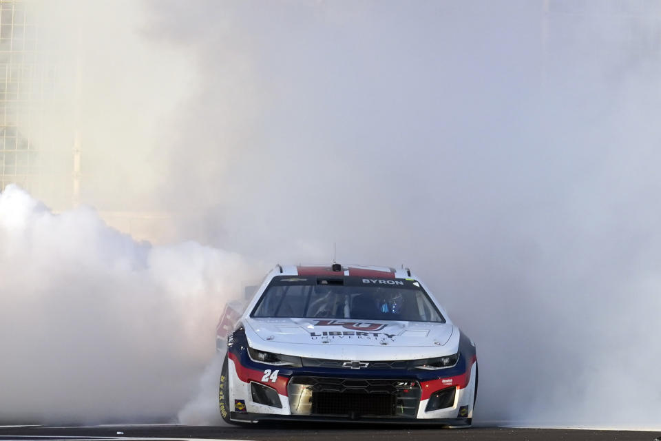 William Byron (24) does a burnout to celebrate after winning a NASCAR Cup Series auto race at Atlanta Motor Speedway in Hampton, Ga., Sunday, March 20, 2022. (AP Photo/John Bazemore)