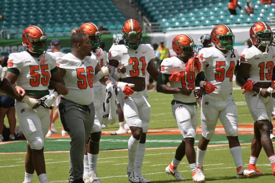 Florida A&M University players walk interlocked during pregame at Orange Blossom Classic, Sept. 4, 2022