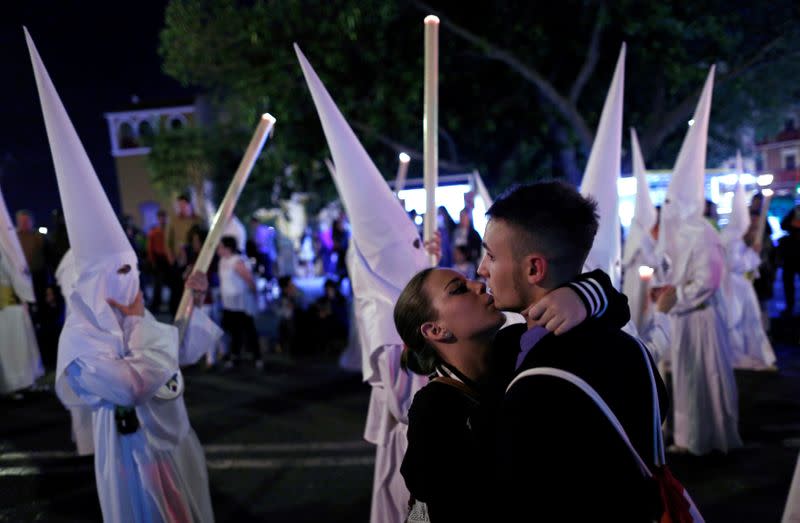 FILE PHOTO: A couple embrace next to the San Gonzalo procession during Holy Week in Seville