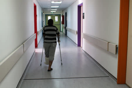 Mohammed, 11, who was injured by a bomb while trying to flee Homs in Syria with his family in a car, walks on crutches inside a Medecins Sans Frontieres hospital in Amman, Jordan, November 20, 2016. Lin Taylor/Thomson Reuters Foundation via REUTERS