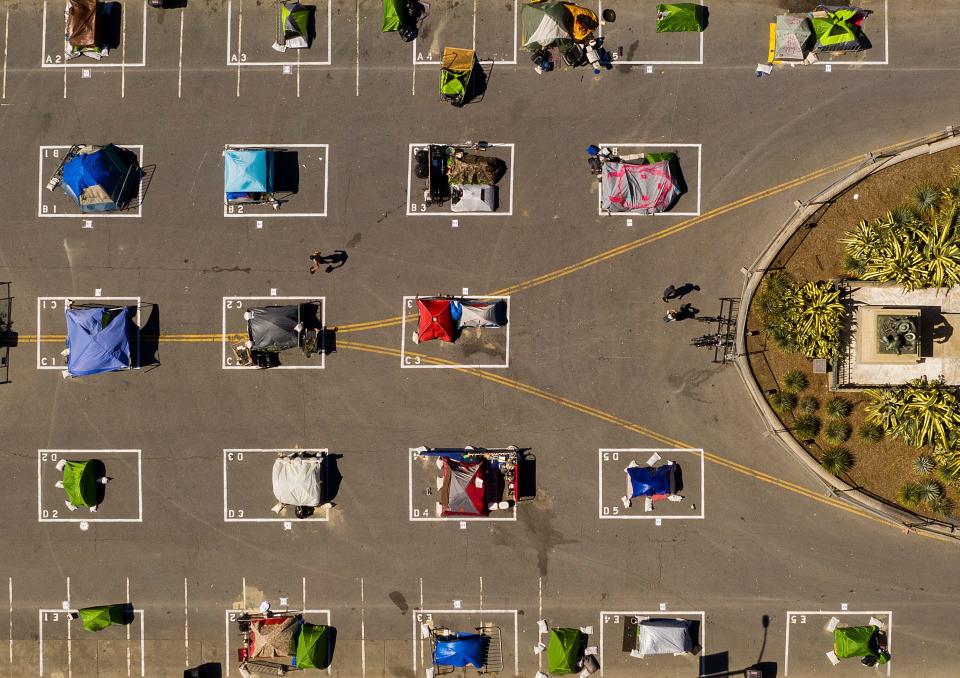 In this May 21, 2020, file photo, rectangles designed to help prevent the spread of the coronavirus by encouraging social distancing line a city-sanctioned homeless encampment at San Francisco's Civic Center.