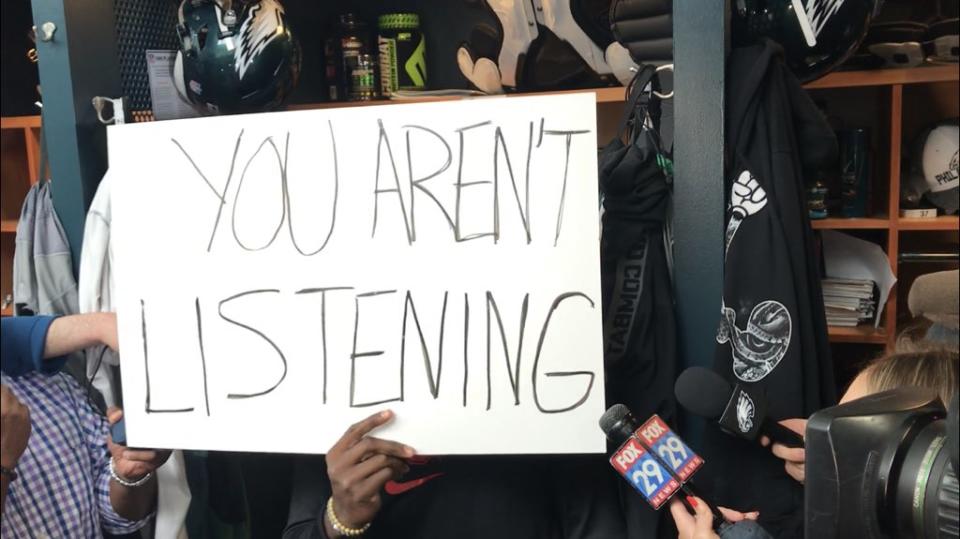 Instead of speaking, Eagles safety Malcolm Jenkins used a series of hand-written signs to send a message on Wednesday. (Mike Garafolo/Twitter)