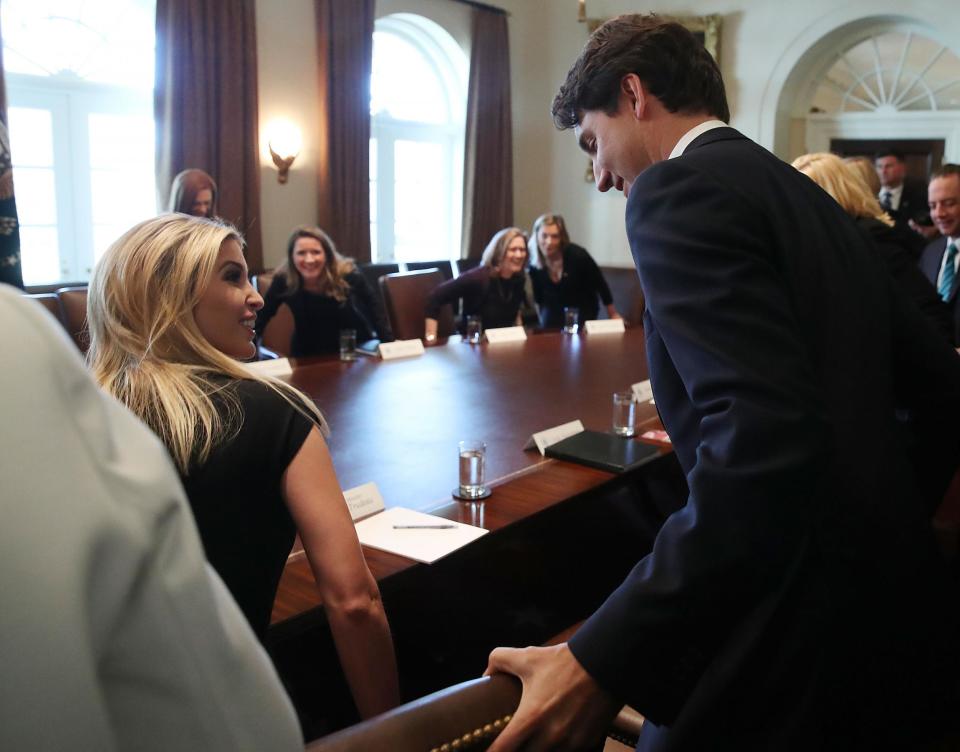 Mr Trudeau helps Ivanka Trump with her chair (Getty)