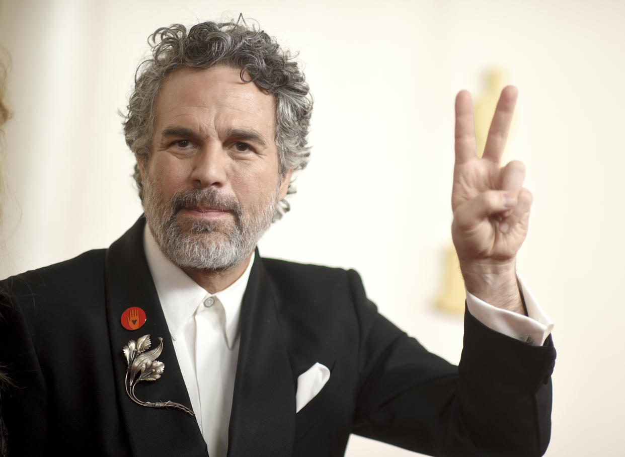 Mark Ruffalo gives the peace sign as he arrives at the Academy Awards in Los Angeles on Sunday.