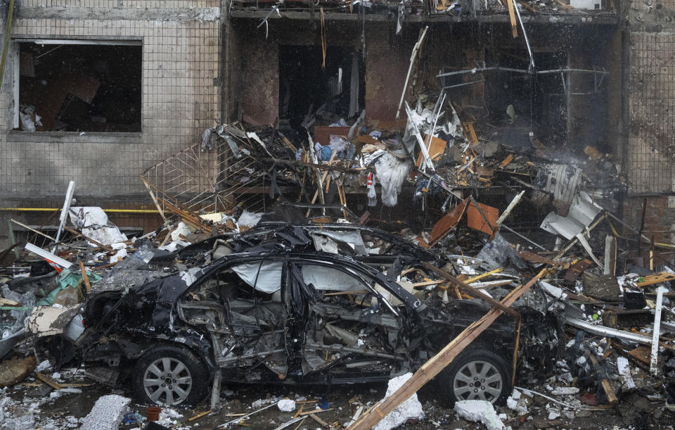 Debris of a destroyed apartment building after a Russian attack in Kyiv, Ukraine, Tuesday, Jan. 2, 2024. (AP Photo/Efrem Lukatsky)