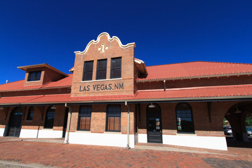 Historic train station building with 'LAS VEGAS, N.M.' sign