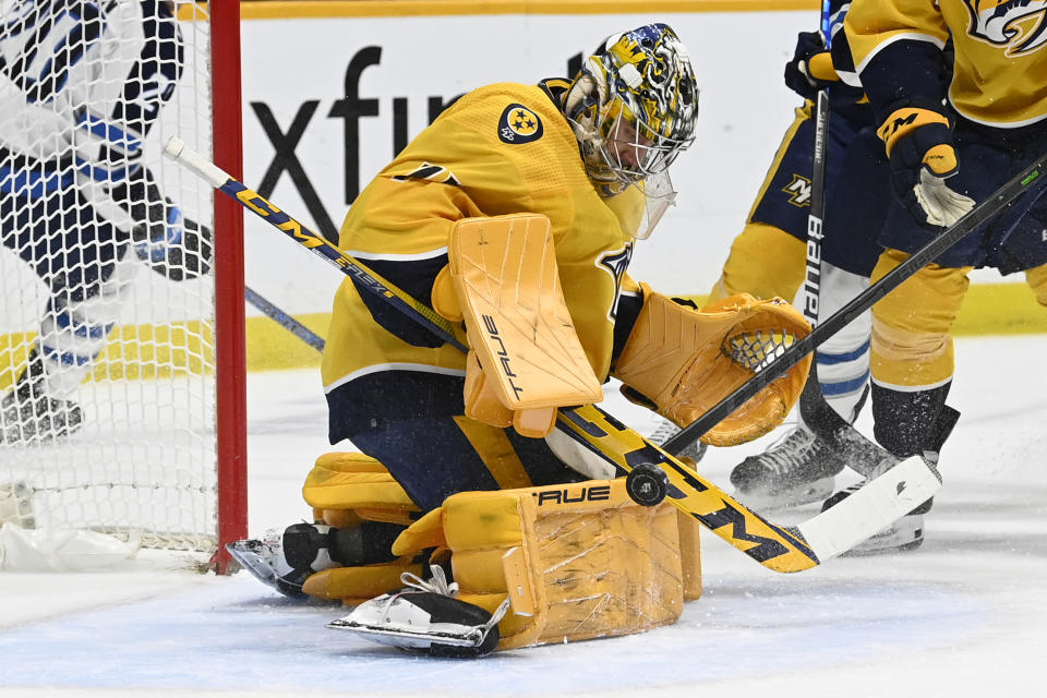 Nashville Predators goaltender Juuse Saros (74) stops a shot by the Winnipeg Jets during the first period of an NHL hockey game Tuesday, Jan. 24, 2023, in Nashville, Tenn. (AP Photo/Mark Zaleski)