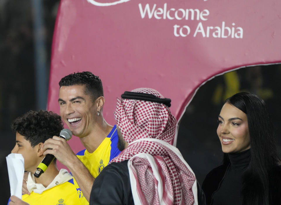 Cristiano Ronaldo and Georgina Rodriguez attend the official unveiling as a new member of Al Nassr soccer club in in Riyadh, Saudi Arabia, Tuesday, Jan. 3, 2023. Ronaldo, who has won five Ballon d'Ors awards for the best soccer player in the world and five Champions League titles, will play outside of Europe for the first time in his storied career. (AP Photo/Amr Nabil)