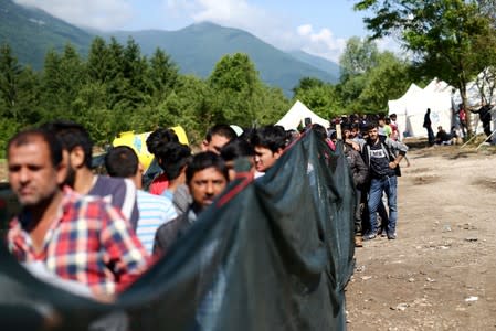 Migrants wait for food at the camp Vucjak in Bihac area