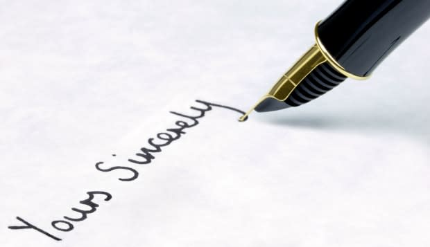 Yours Sincerely written on watermarked textured paper using a gold nibbed fountain pen Focal point is on the text