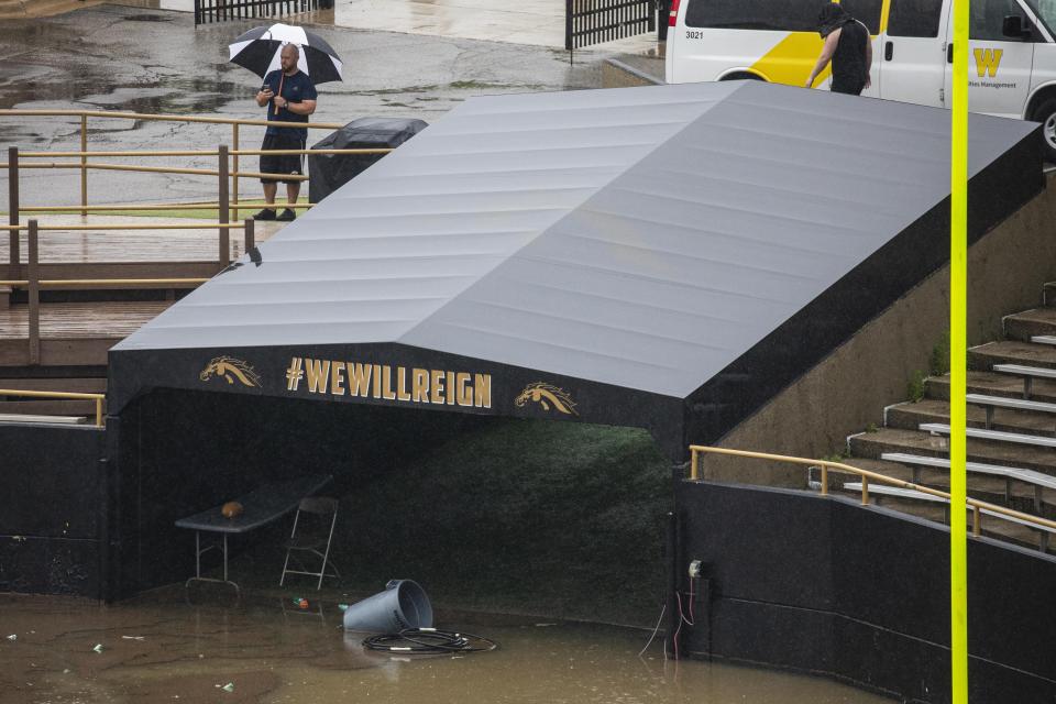 A man takes pictures of the flooded Waldo Stadium  on the campus of Western Michigan University in Kalamazoo, Mich., Thursday, June 20, 2019. (Photo: Joel Bissell/Kalamazoo Gazette via AP)