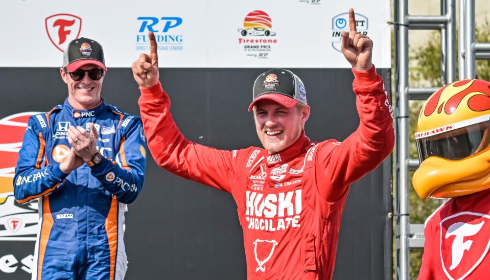 PNC Chip Ganassi Racing driver Scott Dixon, left, claps as Huski Chocolate Chip Ganassi Racing driver Marcus Ericsson steps onto the Victory Lane podium after winning the Grand Prix of St. Petersburg auto race Sunday, March 5, 2023, in St. Petersburg, Fla. (AP Photo/Steve Nesius)
