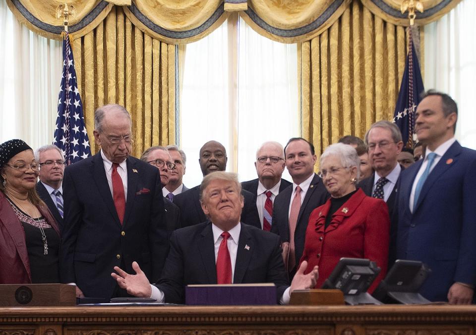 Then-President Donald Trump signs the First Step Act into law on 21 December, 2018. (AFP via Getty Images)