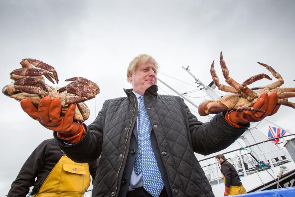 Prime Minister Boris Johnson holding crabs caught on the Carvela at Stromness Harbour in Stromness during a visit to the Highlands and Northern Isles of Scotland. (PA)