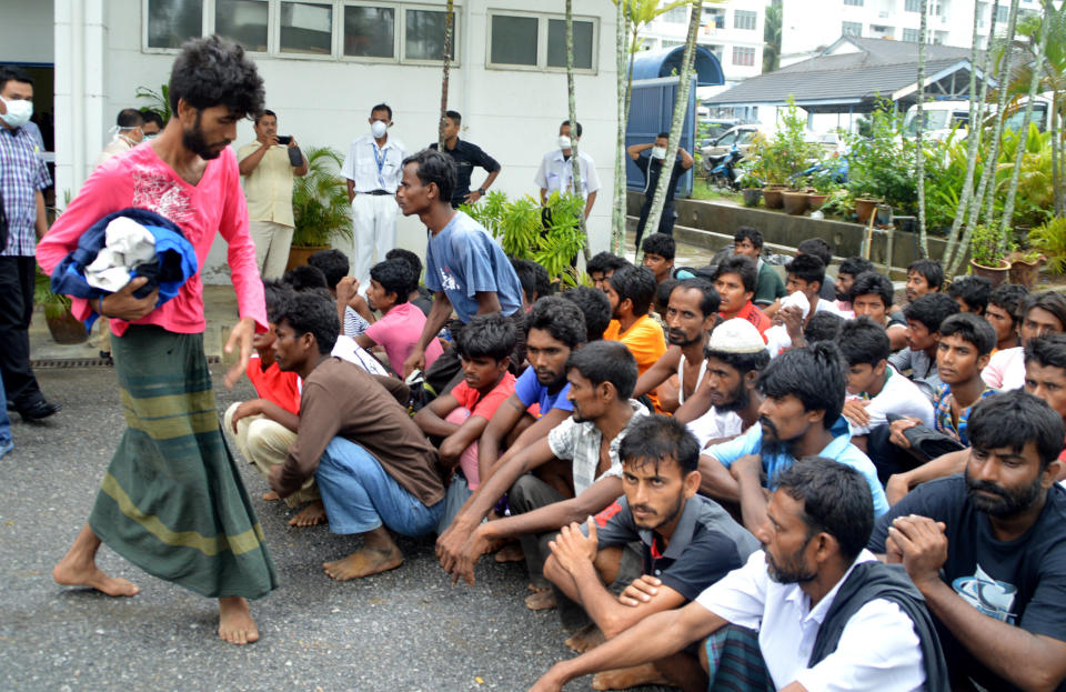 Immigrants from Myanmar and Bangladesh arrive at the Langkawi police station's multi purpose hall in Langkawi, Malaysia on Monday, May 11, 2015. (AP Photo/Hamzah Osman)
