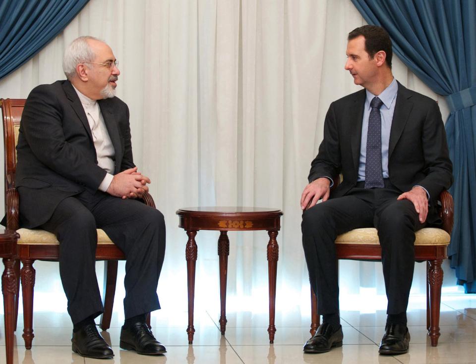 In this photo released by the Syrian official news agency SANA, Iranian Foreign Minister Mohammad Javad Zarif, left, meets with Syrian President Bashar Assad, right, in Damascus, Syria, Wednesday, Jan. 15, 2014. Assad and Zarif have held talks about next week's United Nations conference in Montreux, Switzerland, aimed at trying to resolve the three-year deadly conflict. (AP Photo/SANA)