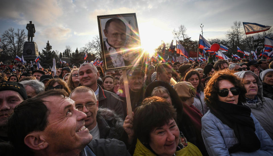 Supporters of Russian President Vladimir Putin gather for a rally to celebrate the fourth anniversary of Russia's annexation of Crimea at Sevastopol's Nakhimov Square on March 14, 2018.