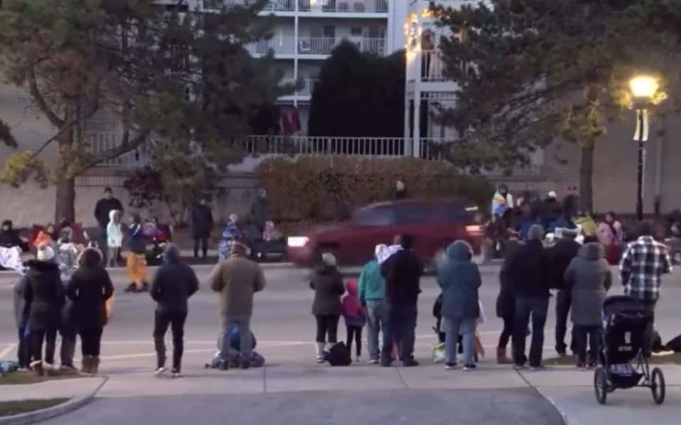 A red SUV speeds past the parade - Twitter