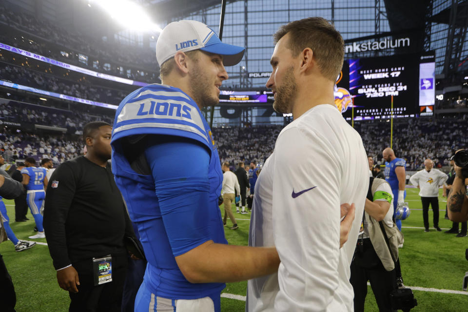 Detroit Lions quarterback Jared Goff, left, talks with injured Minnesota Vikings quarterback Kirk Cousins after an NFL football game, Sunday, Dec. 24, 2023, in Minneapolis. The Lions won 30-24. (AP Photo/Bruce Kluckhohn)