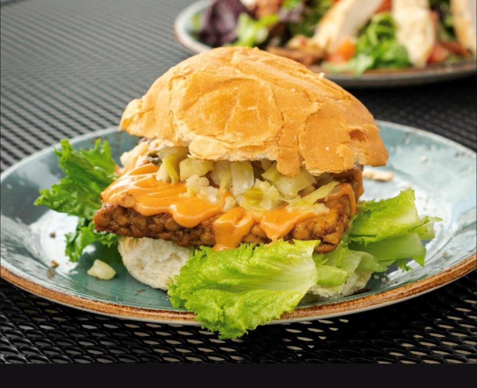 The Farmhouse Tempeh Sandwich is a plant-based dish offered at Early Girl Eatery.