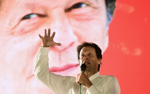 Pakistani cricket star-turned-politician and head of the Pakistan Tehreek-e-Insaf (PTI) Imran Khan addresses a political campaign rally ahead of the general election in Islamabad on July 21, 2018 - Credit: Farooq Naeem/AFP