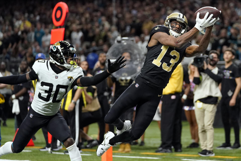 New Orleans Saints wide receiver Michael Thomas (13) makes a catch for a touchdown in front of Jacksonville Jaguars cornerback Montaric Brown (30) in the second half of an NFL football game in New Orleans, Thursday, Oct. 19, 2023. (AP Photo/Gerald Herbert)