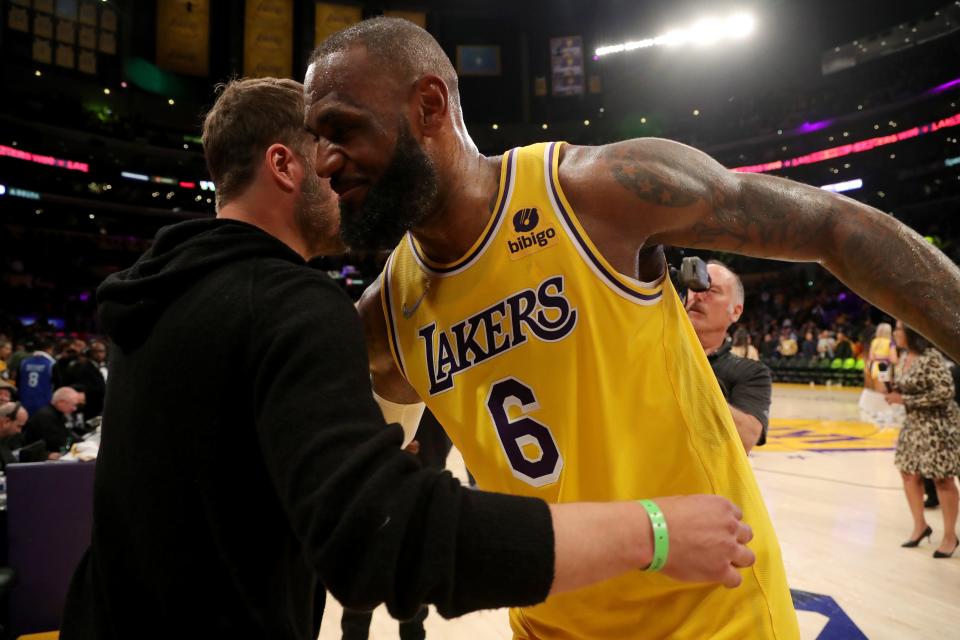 Lakers forward LeBron James hugs Rams quarterback Matthew Stafford after defeating the Golden State Warriors, 124-116, at Crypto.com Arena, March 5, 2022 in Los Angeles.