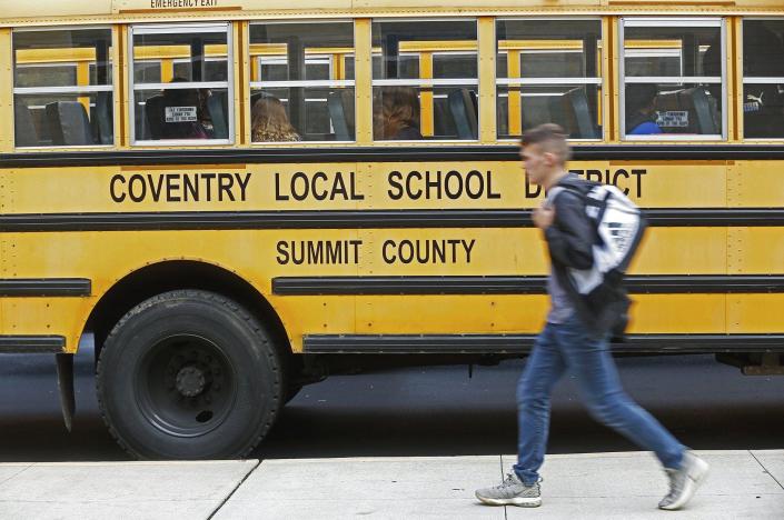 Students load onto buses at the end of a school day in November in Coventry Township.