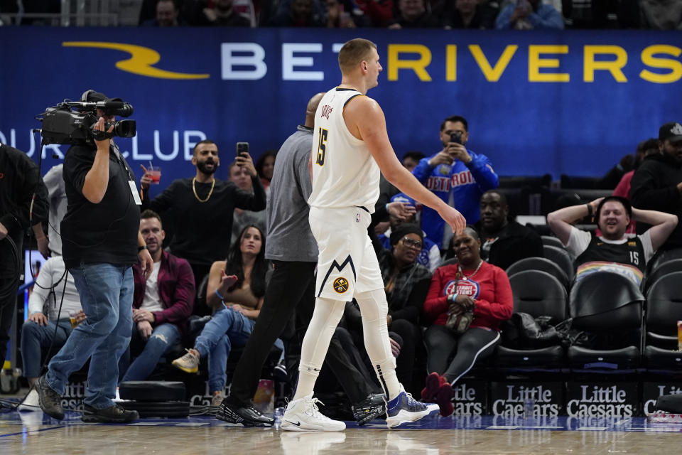 Denver Nuggets center Nikola Jokic (15) walks to the locker room afte his second technical foul during the first half of an NBA basketball game against the Detroit Pistons, Monday, Nov. 20, 2023, in Detroit. (AP Photo/Carlos Osorio)