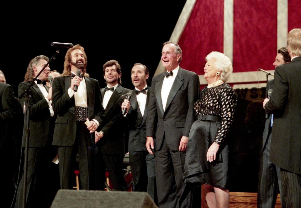 Former President George H.W. Bush and First Lady Barbara Bush, center, share the stage with the Oak Ridge Boys, their favorite act, Eddie Rabbitt, Lee Greenwood and other performers during their 50th wedding anniversary party in Nashville Jan. 8, 1995 at the Grand Ole Opry House.