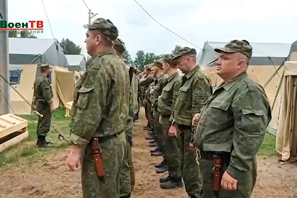 Belarusian soldiers listen to an officer prior to a training by mercenary fighters from Wagner private military company in a  Belarusian army camp, in a video released by the Belarusian Defence Ministry on July 14 (AP)