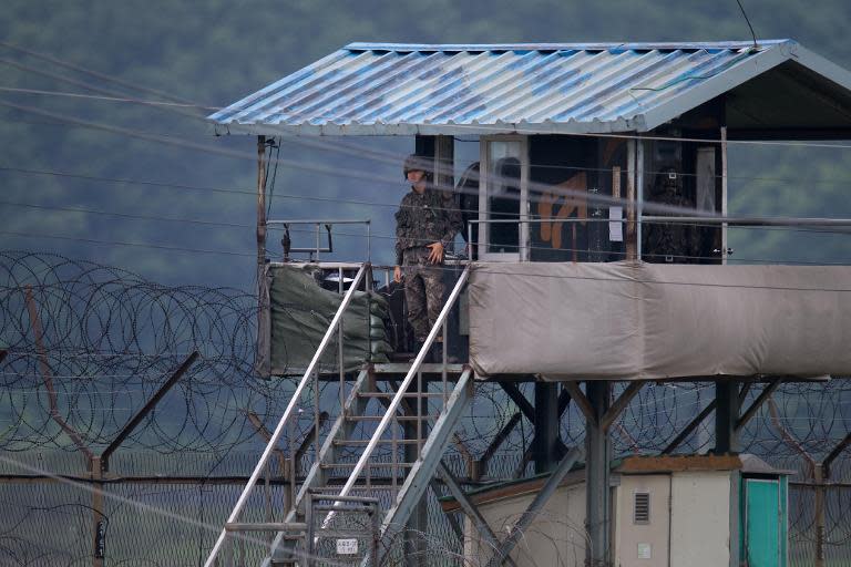 A South Korean soldier looks out from his guard post near the Demilitarized Zone (DMZ) dividing the two Koreas, June 7, 2013