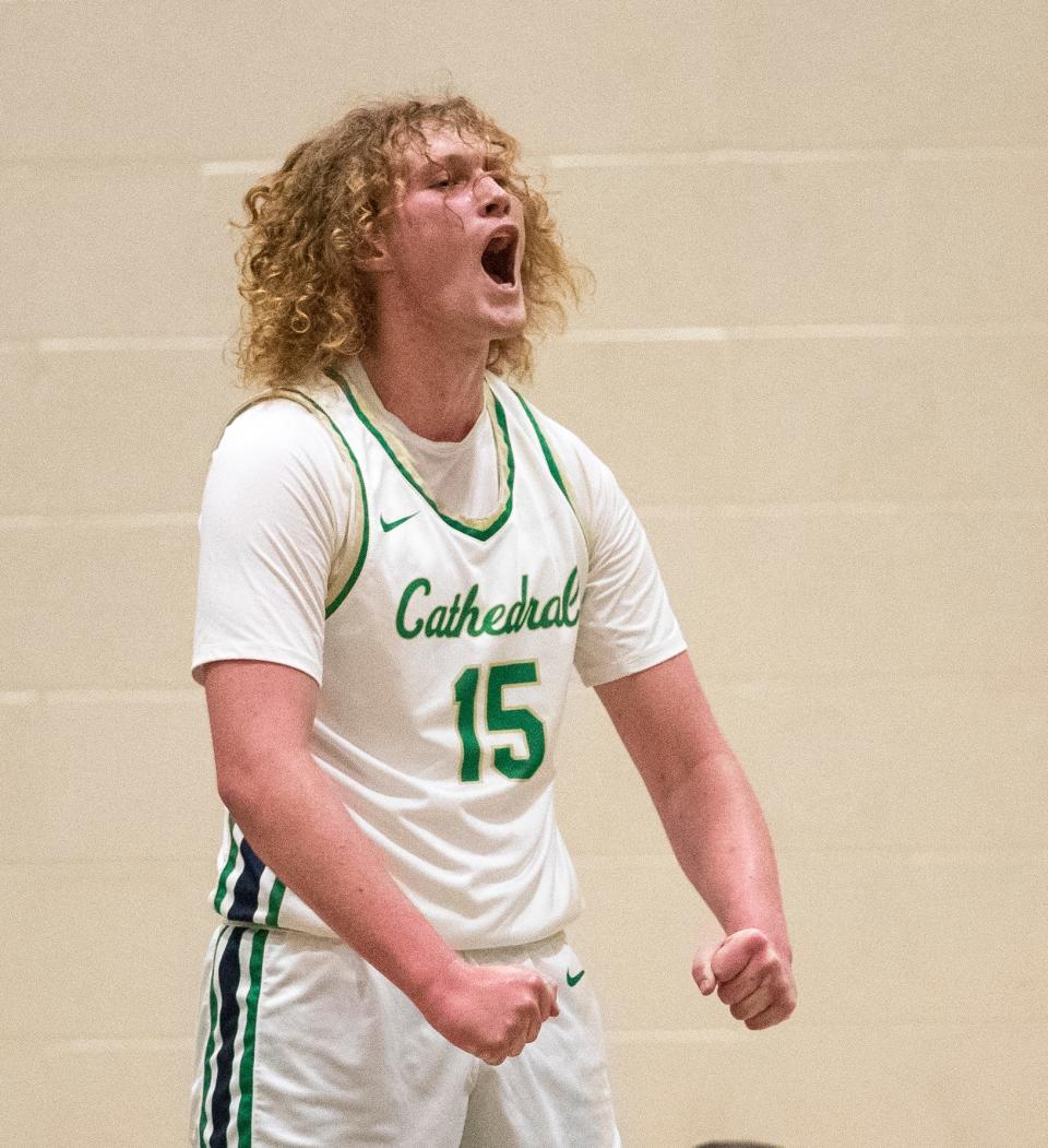 Cathedral's Jake Davis (15) yells after making a key basket against Carmel in January.