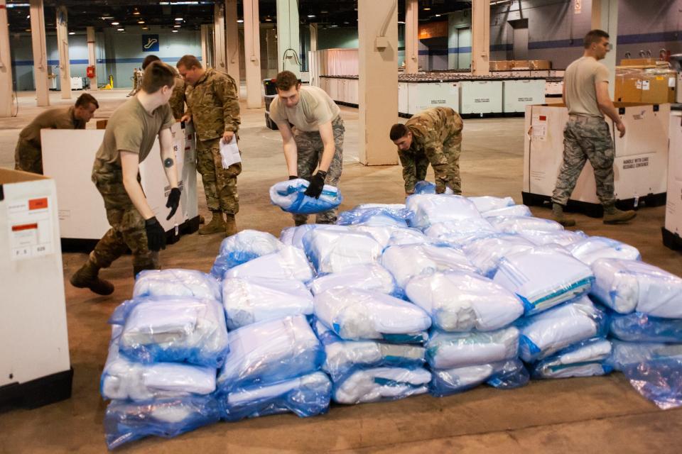 Members of the Illinois Air National Guard assemble medical equipment at the McCormick Place Convention Center in response to the COVID-19 pandemic in Chicago on March 30, 2020.