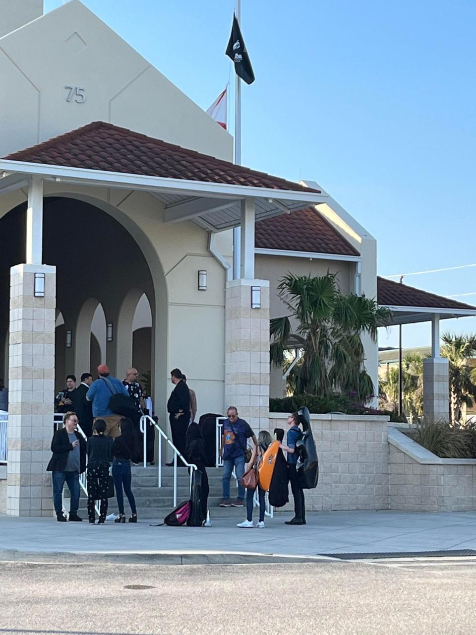 Musicians wait outside the Charlotte Harbor Event and Conference Center on April 2 after the Punta Gorda Symphony abruptly canceled a concert about two hours before it was to begin.