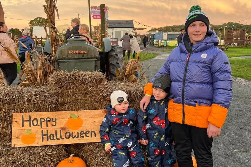 LJ pictured with his little brothers, Charlie-Boy, four, and Ronnie-Jay, two, at a pumpkin patch