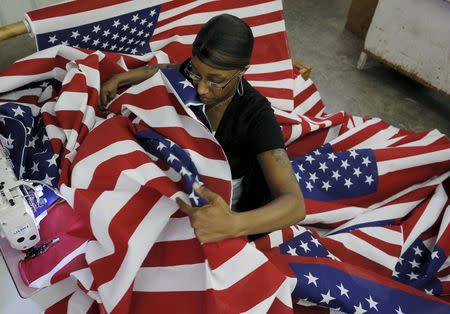 Keisha Hardman cuts and sews U.S. flags at Valley Forge's manufacturing facility in Lane, South Carolina June 23, 2015. REUTERS/Brian Snyder