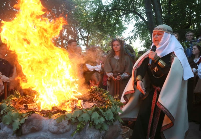 Inija Trinkuniene, high priestess of Lithuania's Romuva neo-pagan community, presides over a fire ritual marking the summer solstice in Vilnius