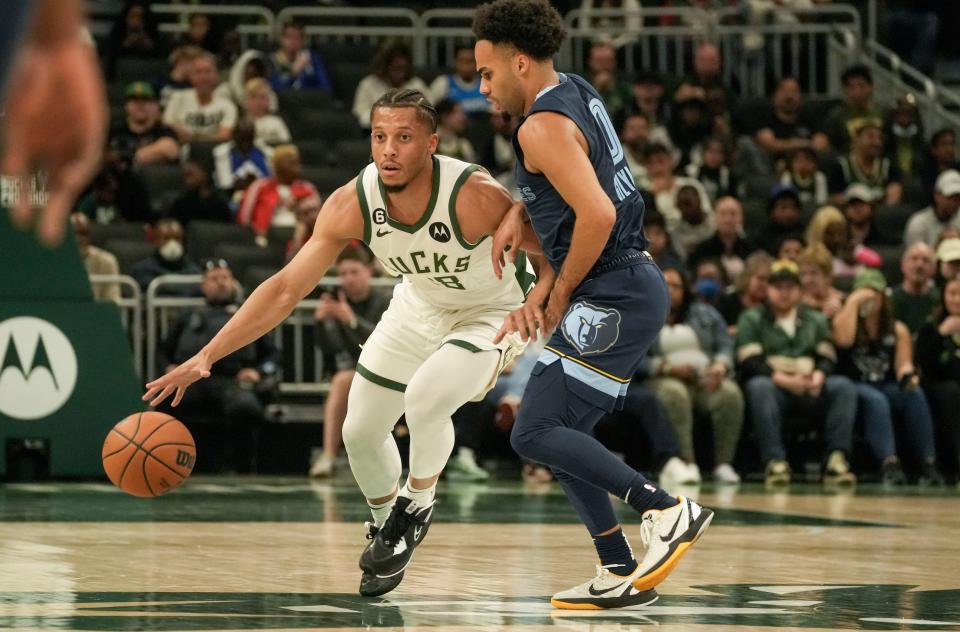 Bucks guard Lindell Wigginton pushes the ball up the court while Grizzlies guard Jacob Gilyard  guards him during the second half of the preseason game Saturday at Fiserv Forum in Milwaukee. The Bucks lost, 107-102.