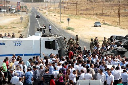 Turkish security forces block a road to stop a convoy, carrying a delegation of the pro-Kurdish Peoples' Democratic Party (HDP), near the southeastern town of Midyat, Turkey, September 9, 2015. REUTERS/Sertac Kayar