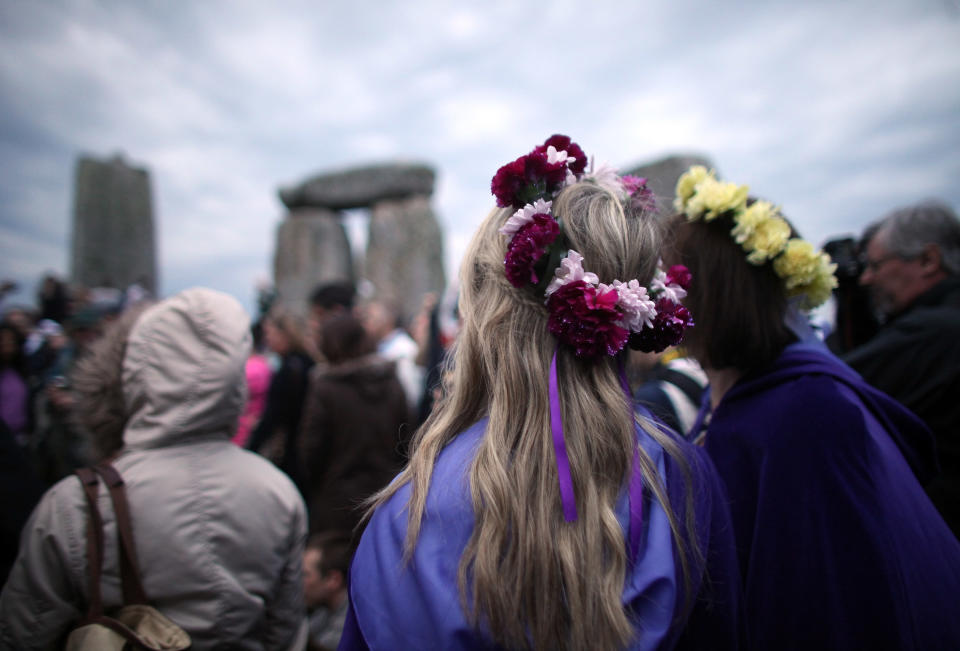 SALISBURY, ENGLAND - JUNE 21:  Solstice revelers celebrate the arrival of the midsummer dawn at the megalithic monument of Stonehenge on June 21, 2012 near Salisbury, England. (Photo by Matt Cardy/Getty Images)