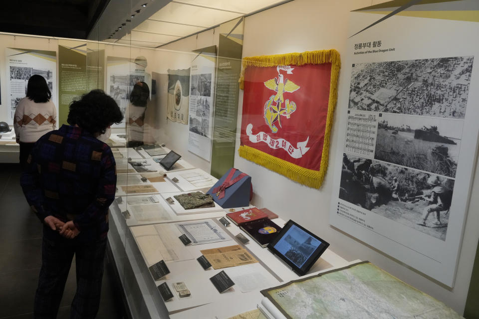 Visitors watch records of South Korean military soldiers during the Vietnam War at the War Memorial of Korea in Seoul, South Korea, Friday, Feb. 17, 2023. South Korea's top military official on Friday insisted the country's soldiers didn't commit any massacres during the Vietnam War and indicated the government will appeal a ruling that ordered compensation for a Vietnamese woman who lost several relatives to a shooting rampage blamed on South Korean marines in 1968. (AP Photo/Ahn Young-joon)