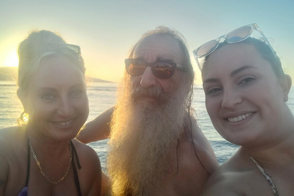 In this January 2023 photo provided by Sherrie Esquivel, left, she poses with her father, Thomas Leonard, and her daughter Destinee Concepcion in Lahaina, Hawaii. Esquivel, of Dunn, N.C., spent frantic days trying to find her father after fires devastated Lahaina this week. Neighbors told her early Friday, Aug. 11, 2023, he was safe, and she only found out ordeals of how he survived by reading an Associated Press article. (Courtesy of Sherrie Esquivel via AP)