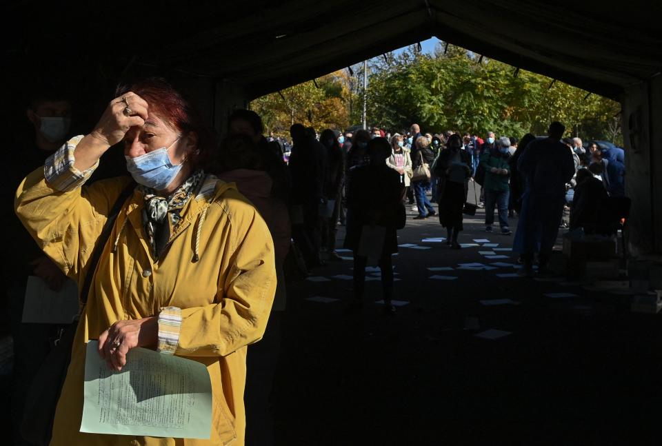 People wait in line to get an anti COVID-19 vaccine during a weekend-long 